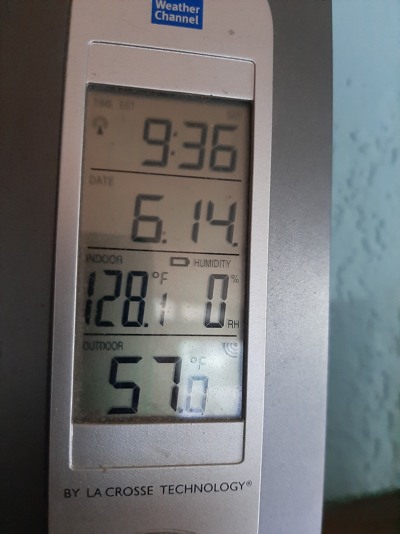 A picture of the indoor thermometer unit showing an indoor temperature of 128 degrees F